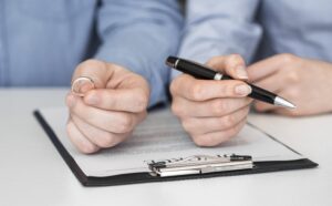 Couple Signing Divorce Documents with a Divorce Attorney