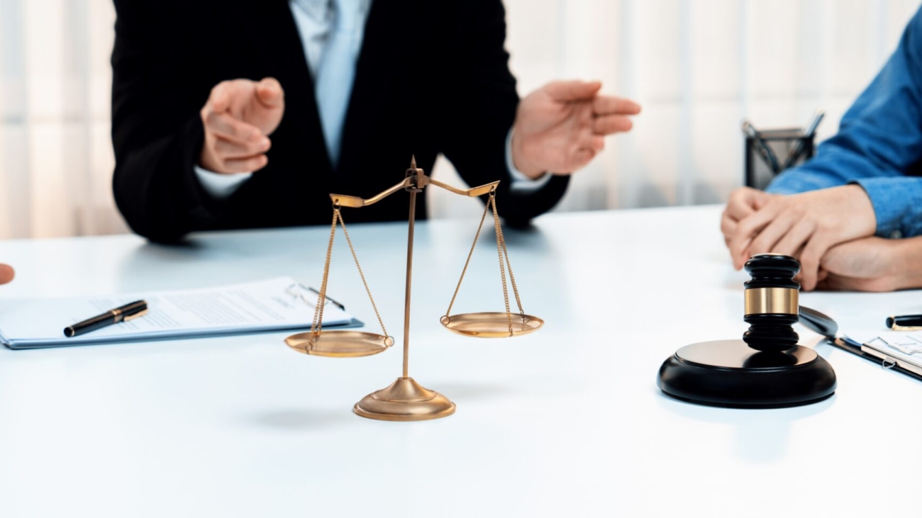 Focused gavel hammer and balance scale of justice on blurred background of lawyer acting as mediator to broke compromise to resolve legal business dispute with negotiation. Panorama Rigid