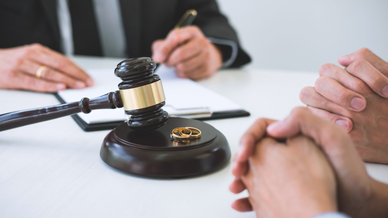 Agreement prepared by lawyer signing decree of divorce (dissolution or cancellation) of marriage, husband and wife during divorce process with male lawyer or counselor and signing of divorce contract.