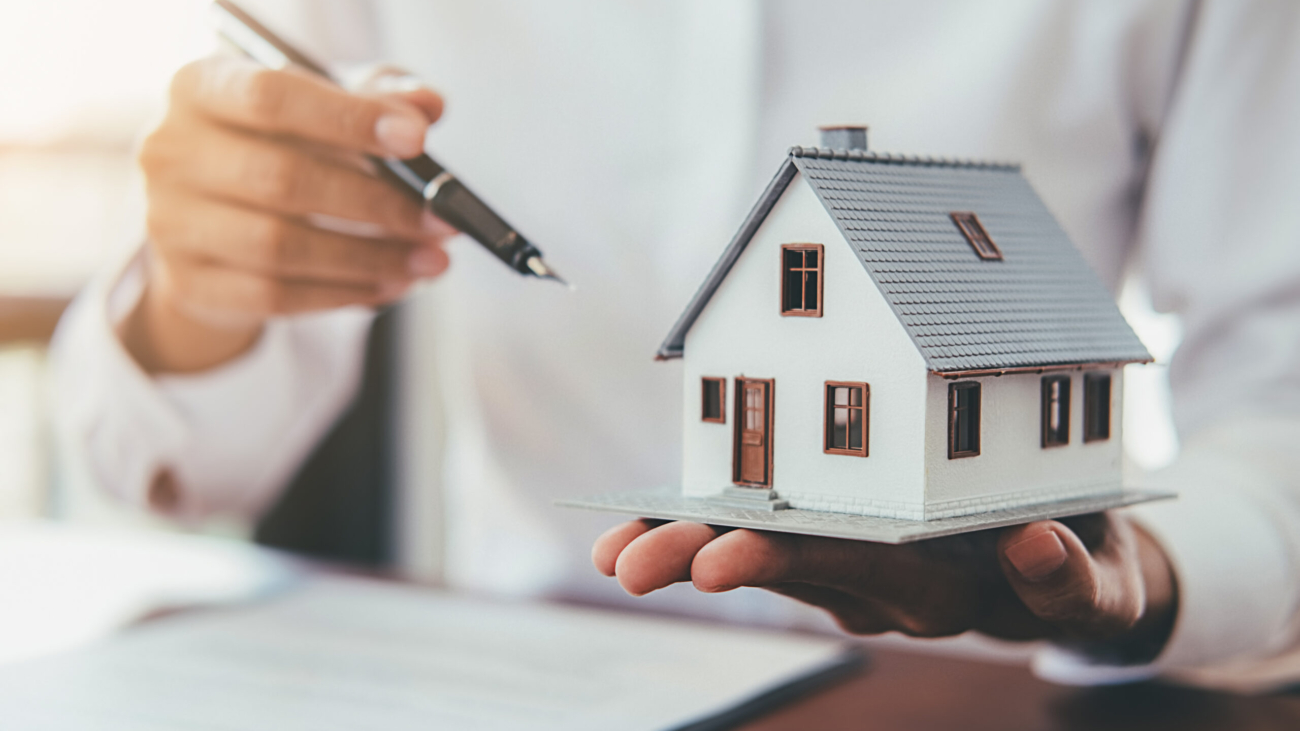 House model with real estate agent and customer discussing for contract to buy house, insurance or loan real estate background.