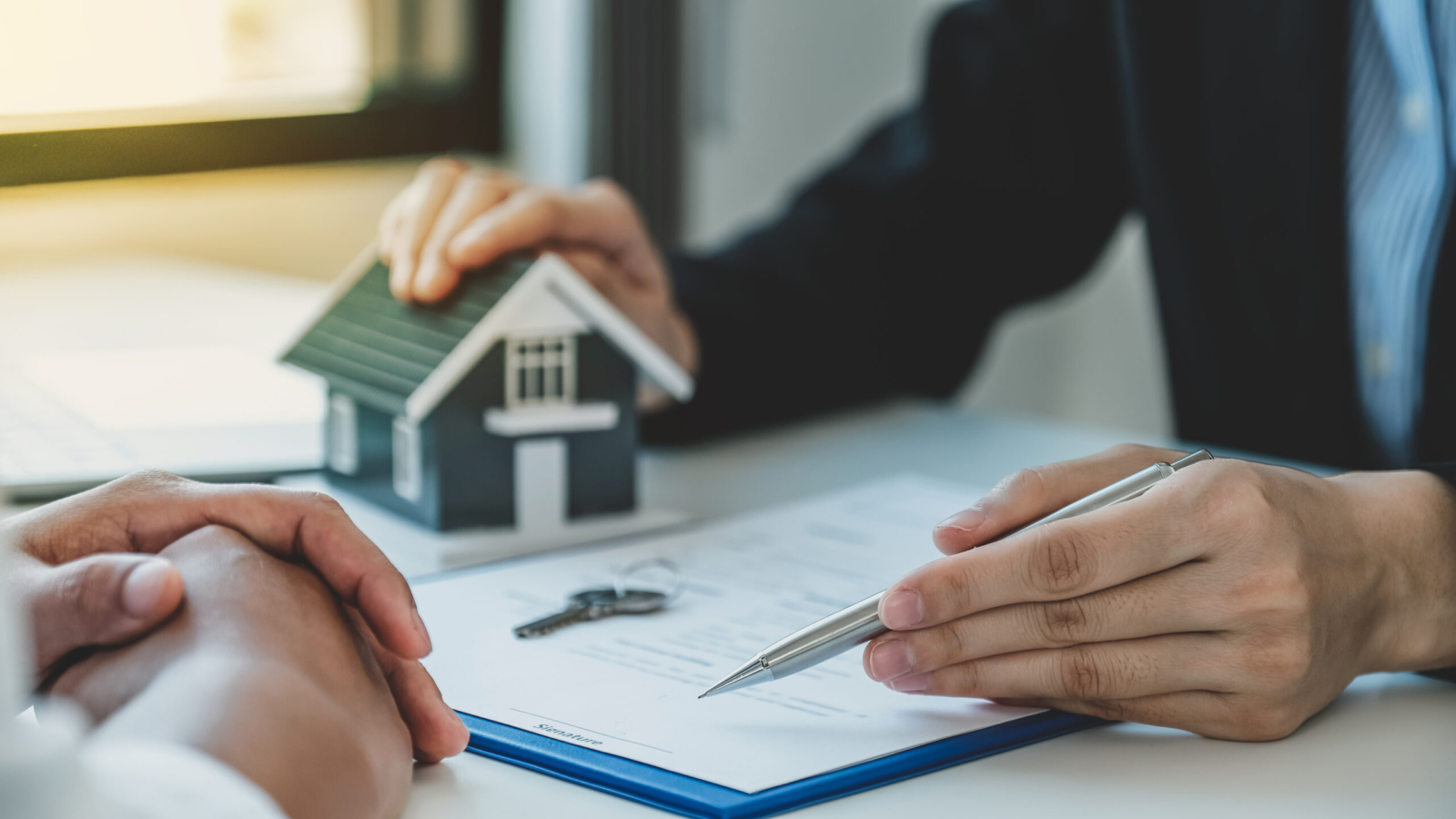 Real estate agent hand holding pen and explain the business contract, rent, buy, mortgage, loan, or home insurance.