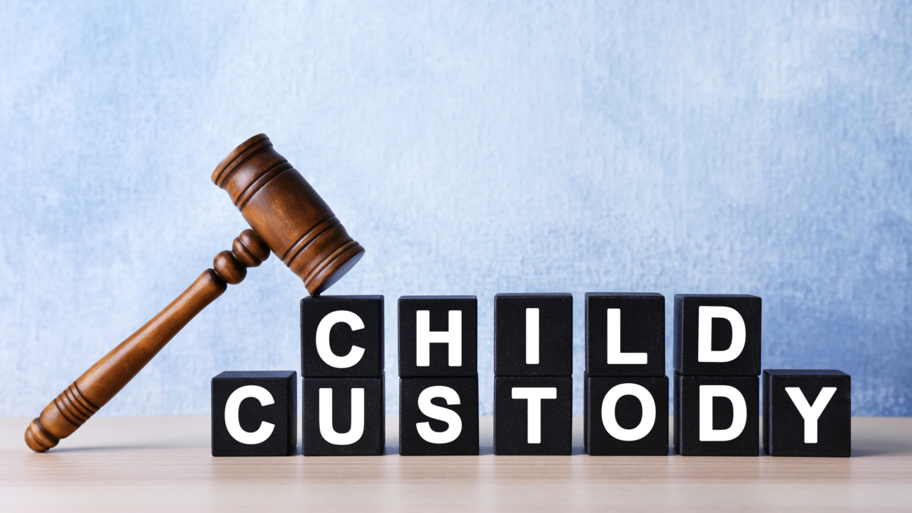 Court gavel and cubes with text CHILD CUSTODY on light background